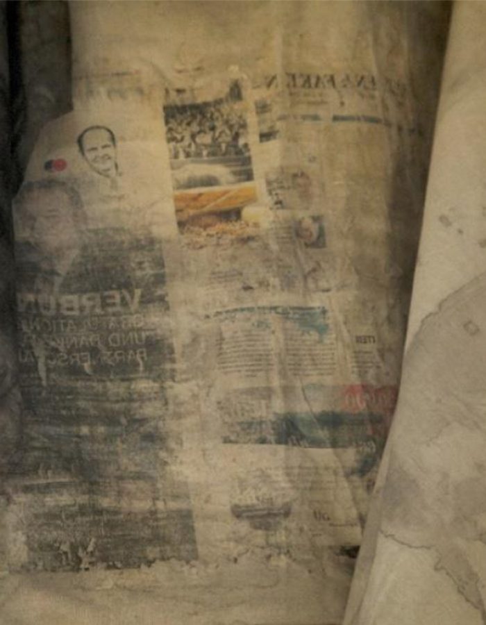 The Noisy Wall I (2017). (Detail). Assorted clays, newspaper cutting, cassava starch, manganese dioxide, gum-Arabic on fabric. Dimension varies